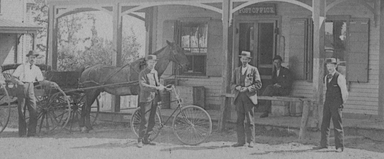 4 men in front of C O Green's store about 1900